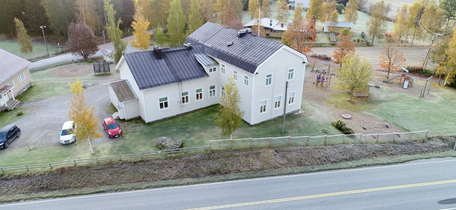 Flygbilder över Sundby skola, delar av skolgården syns. Det är barmark.