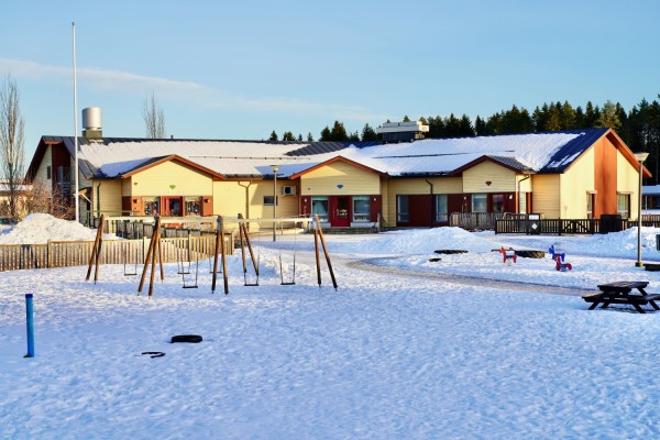 Daghemmet Diamanten i snöig omgivning. Gungor i förgrunden.